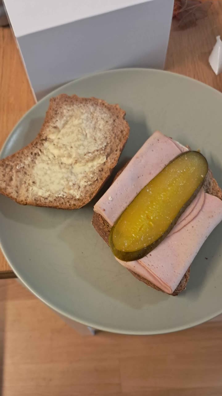 Originalfoto: belegtes Brot mit Fleischkäse und Essiggurke auf einem Teller